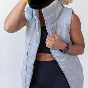 Asymmetrical zip front quilted vest
4 1/2" stand collar Welt pockets